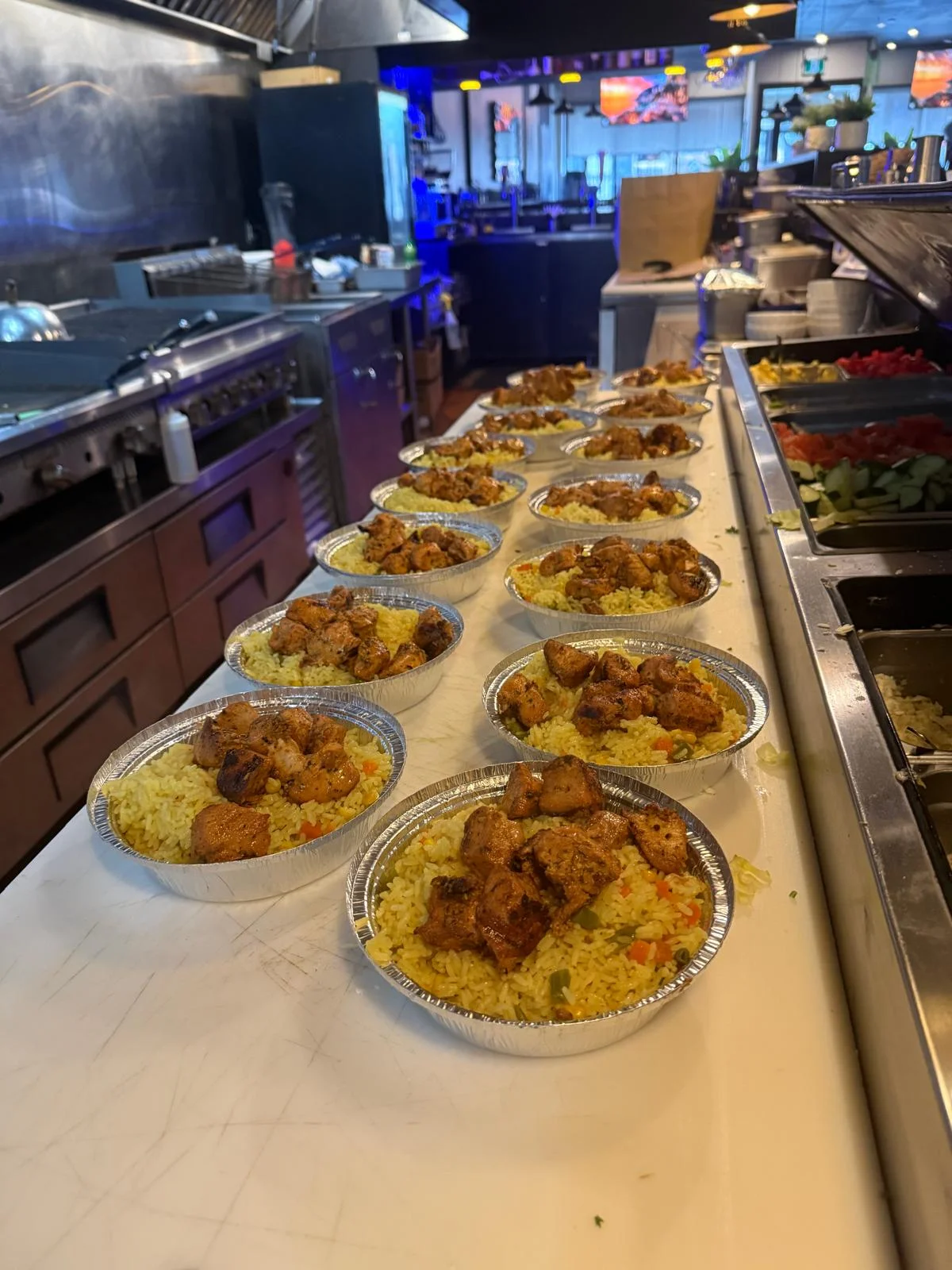 Freddy's catering chicken and rice platters lined up for large order